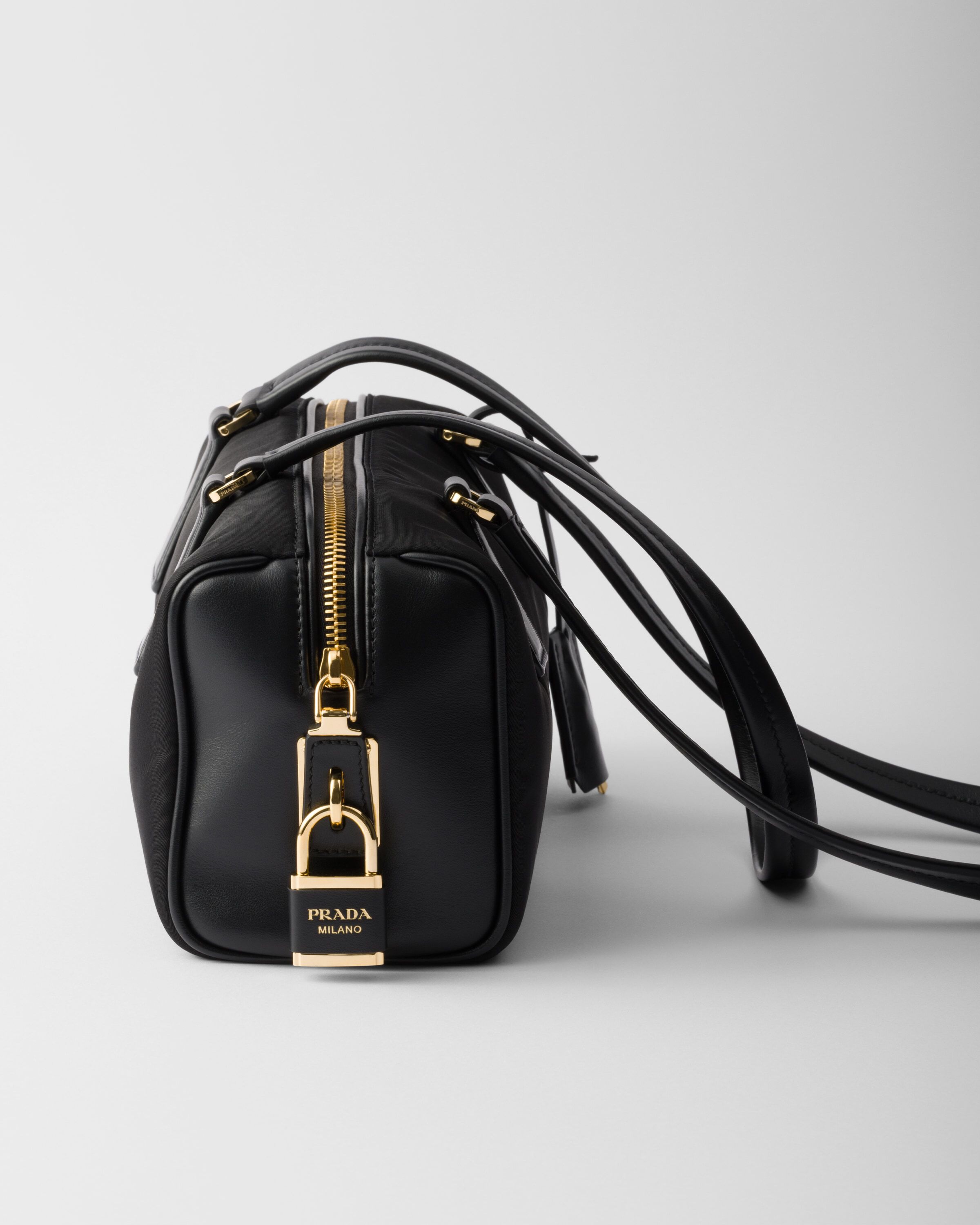 Re Nylon and leather medium top handle bag with padlock
