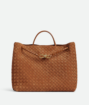 Top handle bag in Intrecciato suede with signature knot detail and sliding cross-body strap.,