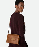 Cross-body bag in Intrecciato piccolo leather with adjustable top handle and sculptural knot closure., , hi-res