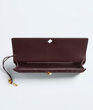 Top handle clutch in supple Intrecciato suede with signature knot closure., , hi-res