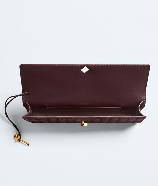 Top handle clutch in supple Intrecciato suede with signature knot closure., , hi-res