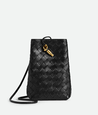 Phone pouch in Intrecciato nappa leather with signature knot closure and sliding strap.,