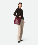 Bucket bag in silky calf leather with signature knot detail and sliding shoulder strap., , hi-res