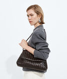 Pouch in Intrecciato leather with flap and drawstring closure, featuring a loop attachment for shoulder carry. , , hi-res