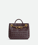 Top handle bag in supple Intrecciato leather with signature knot detail and tubular leather braided metal chain.