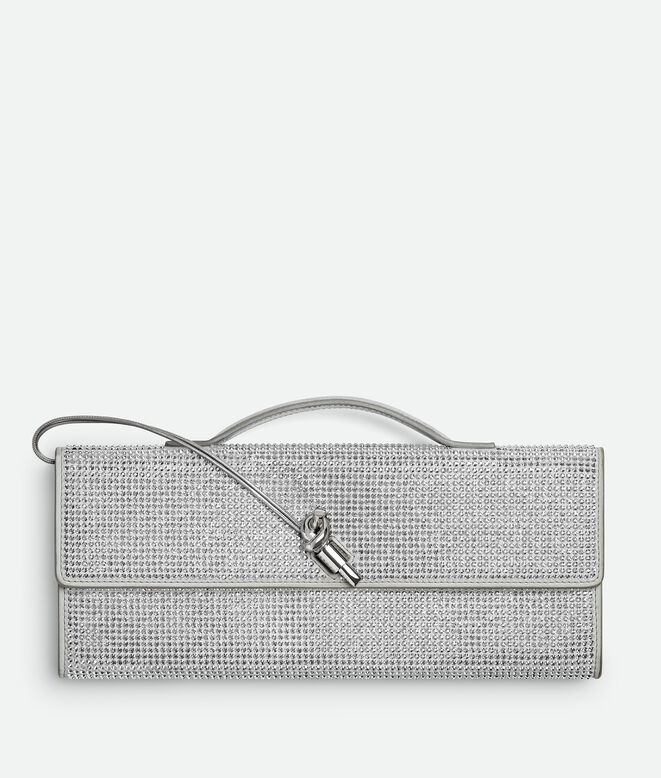 Top handle clutch in supple leather with all-over crystal detailing and signature knot closure., , hi-res