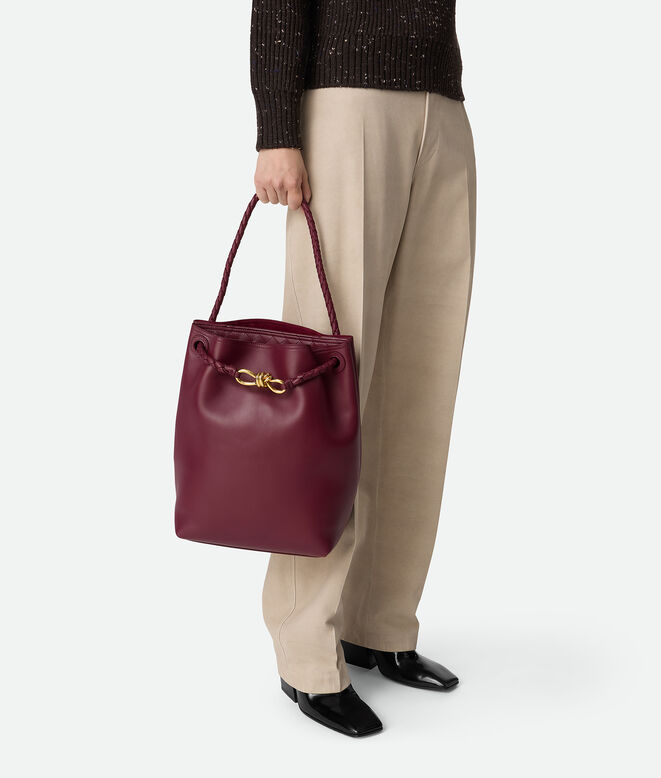 Bucket bag in silky calf leather with signature knot detail and sliding shoulder strap., , hi-res