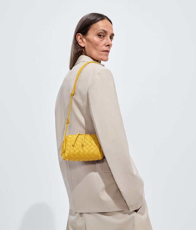 Pouch in Intrecciato nappa leather with adjustable tubular strap featuring sliding knot details., , hi-res